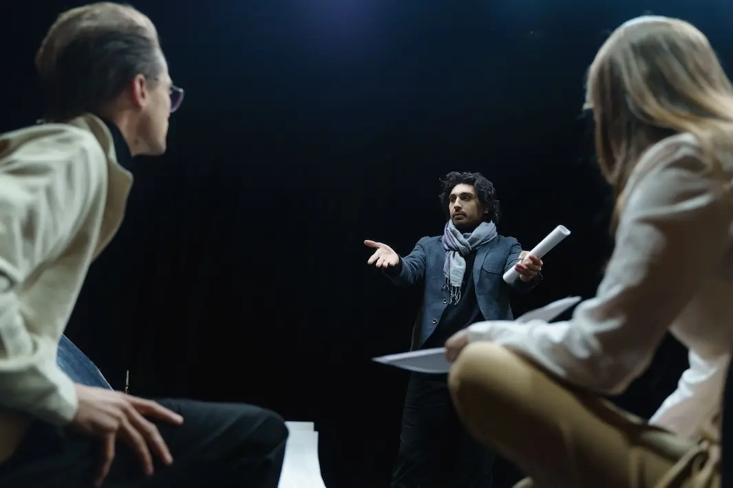 a director talks to two actors about blocking.