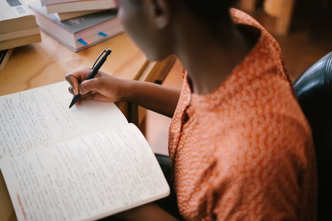 a dramaturg takes note on a notepad