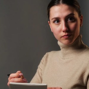 an actress holding a script looks into the camera